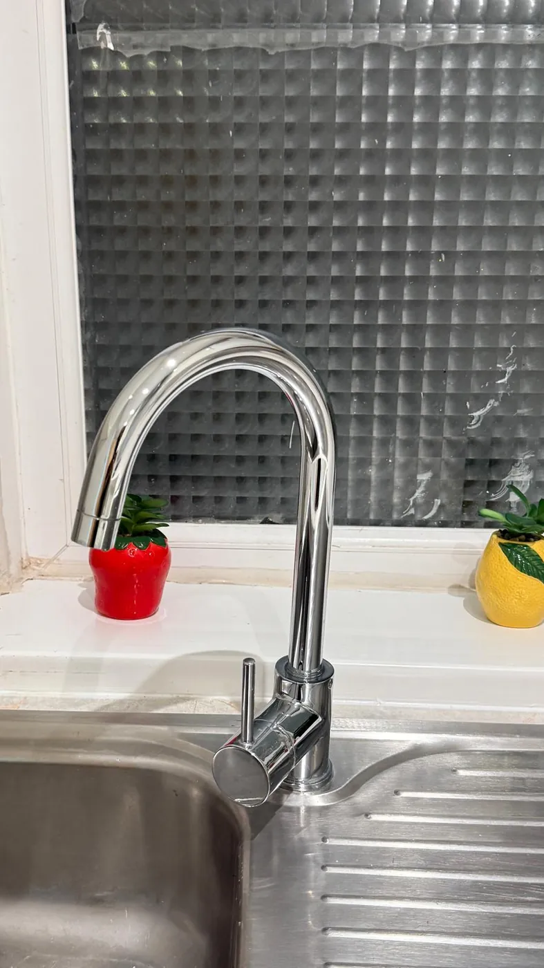 Chrome kitchen tap polished after a Rise N Shine clean